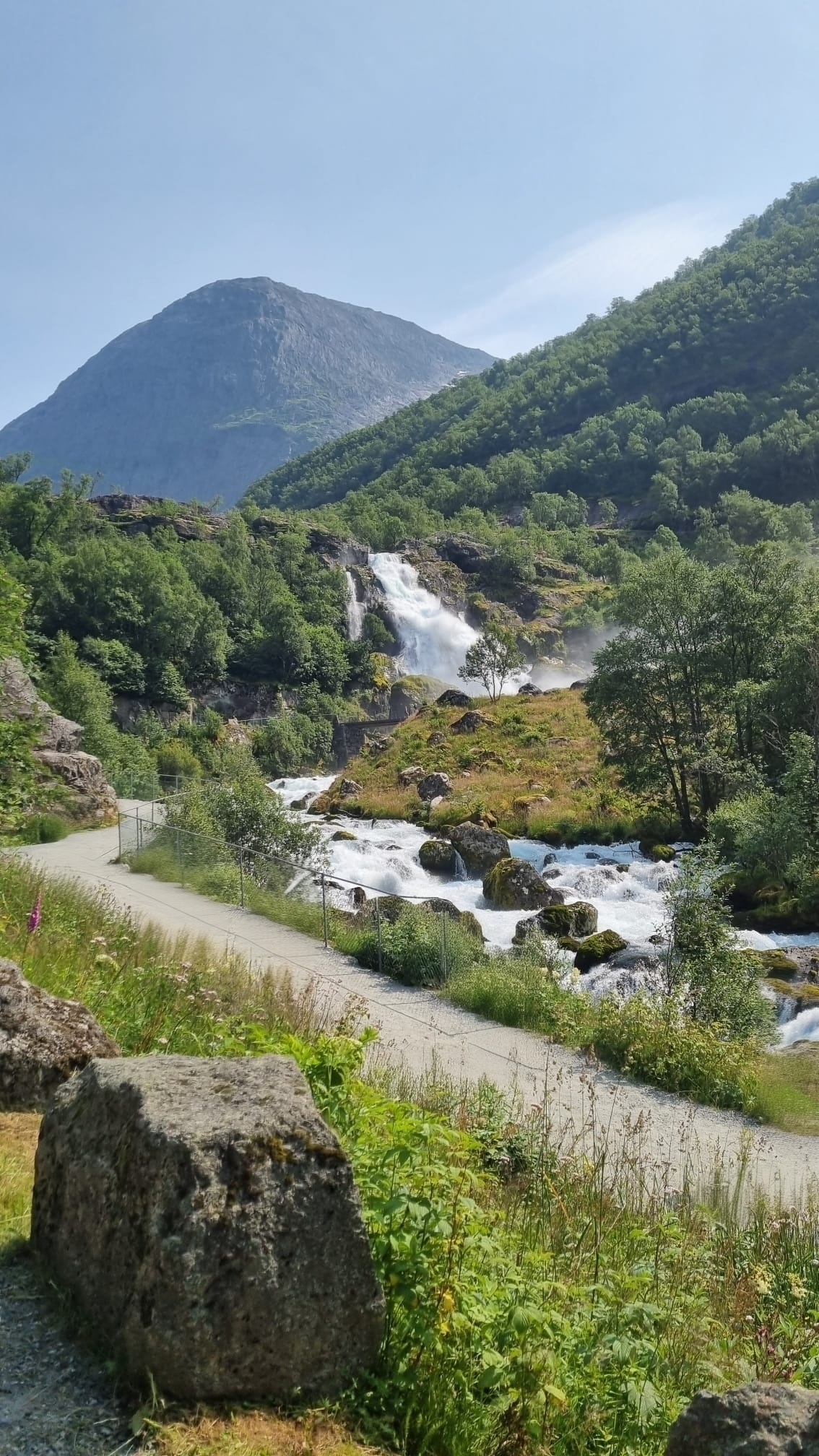 The path along the river up towards Briksdalsbreen, with a waterfall on the mountainside